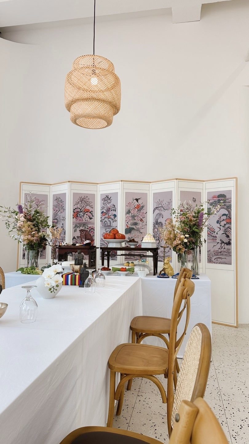 Small private first-birthday event room with a traditional folding screen and guest table