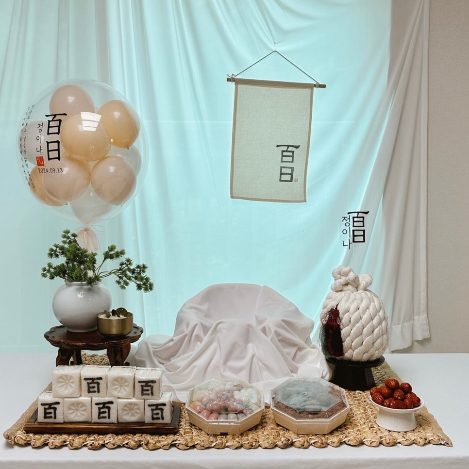 A rented hundred-day table standing empty at home before rice cakes and photographs were added