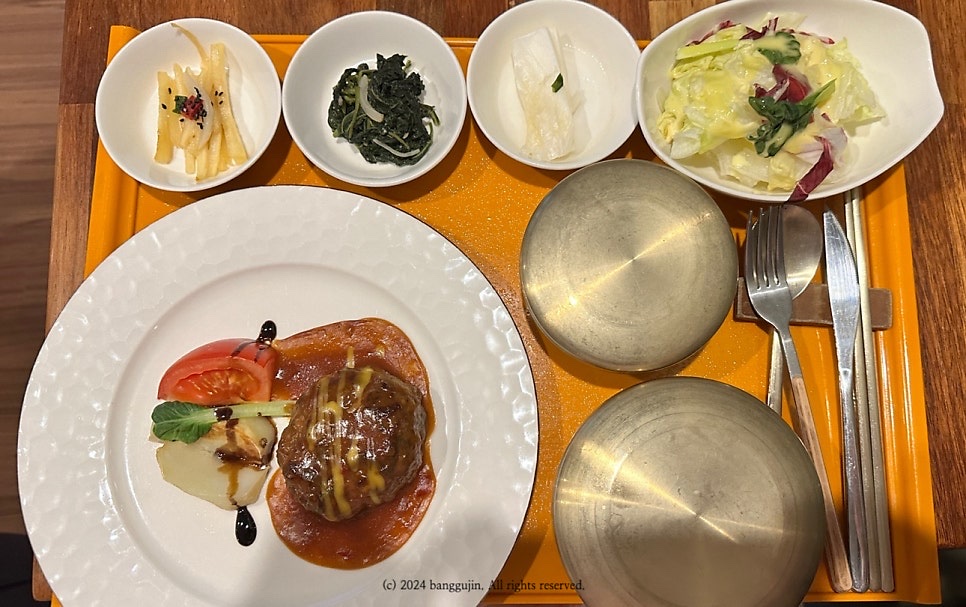A postpartum care centre meal tray with soup, rice and side dishes