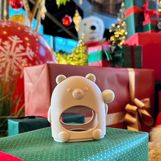 Pink silicone teether standing upright on a clean tabletop