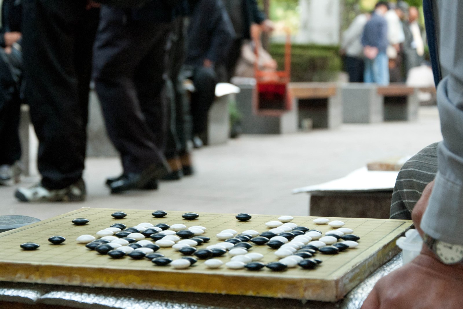A baduk board in the middle of a game, black and white stones forming territories
