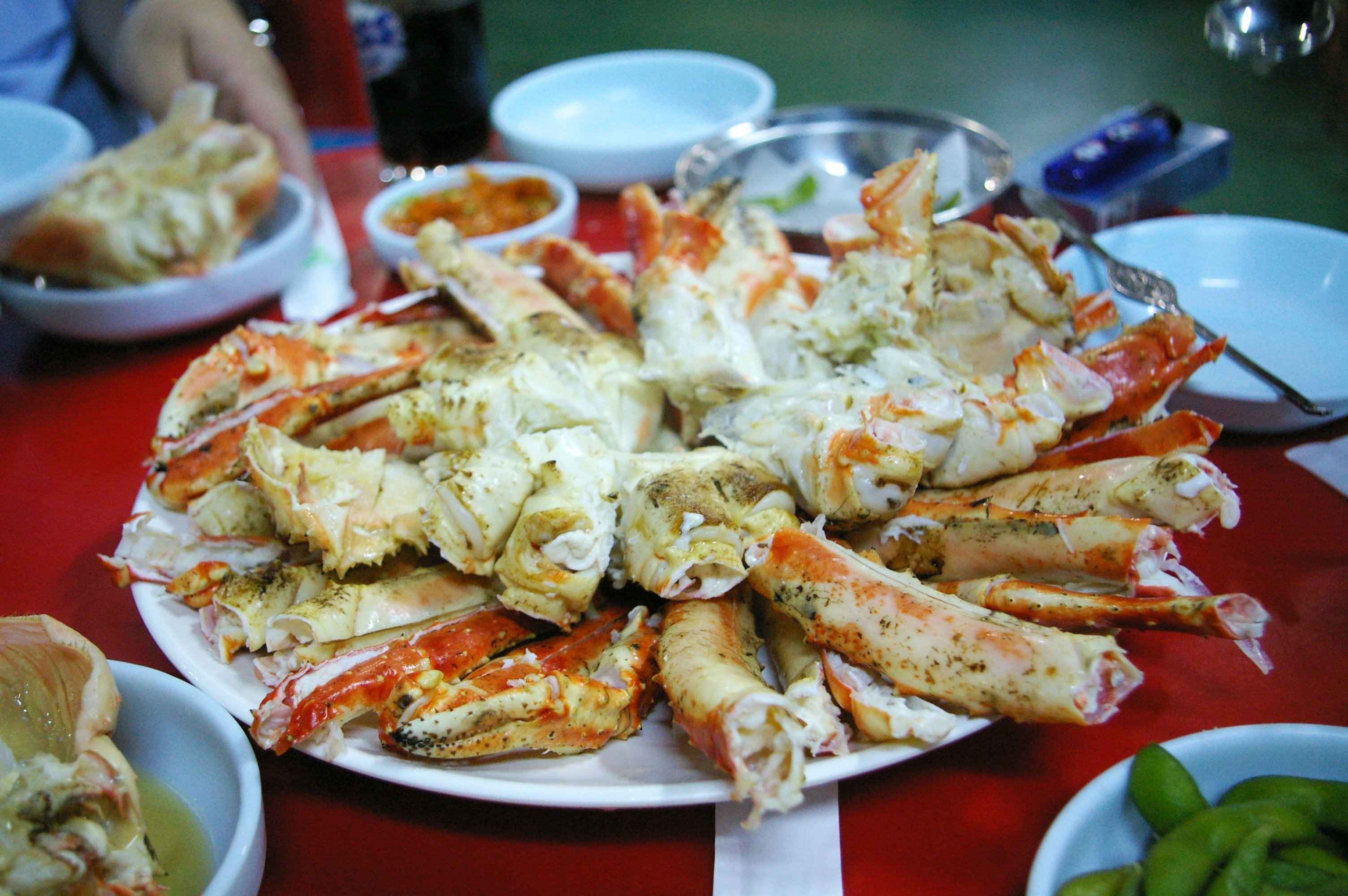 Steamed blue crabs turned shell-side up on a plate, their shells red-orange from cooking
