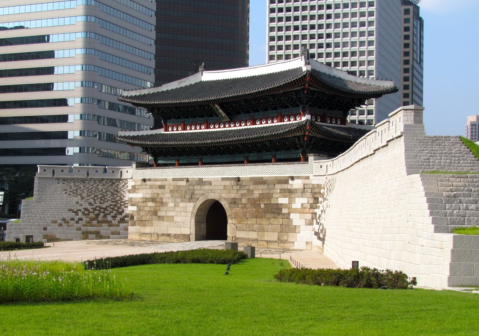 Sungnyemun gate in Seoul, a stone-and-timber city gate with a two-tier tiled roof, seen from the front